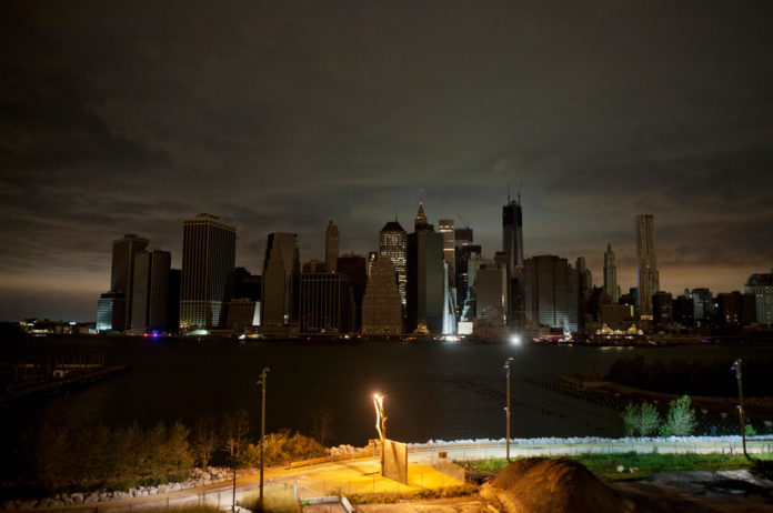 CLOUDS HANG OVER the darkened lower Manhattan skyline at night in New York, U.S., on Tuesday, Oct. 30, 2012. / BLOOMBERG FILE PHOTO/VICTOR J. BLUE