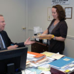 ON A MISSION: Attorney James Aukerman says philanthropically inclined businesses need to align their charities with their missions. Above, he speaks to legal secretary Susan Theriault. / PBN PHOTO/BRIAN MCDONALD