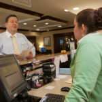 Youth soccer tourney score for R.I. hotels ON THE BALL: Doug Brady, general manager of the South Kingstown Holiday Inn, anticipates the U.S. Youth Soccer Region I Tournament to be a great success. Above, he speaks with hotel employee Elizabeth Ashley. / PBN PHOTO/DAVID LEVESQUE