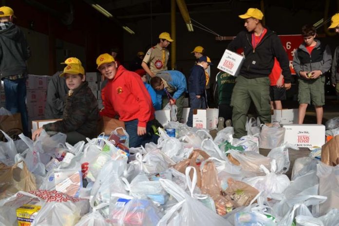 Narragansett Council Boy Scouts sort food for the 25th annual Scouting for Food Drive on Nov. 3. Thousands of Boy Scouts collected nonperishable food items for the Rhode Island Community Food Bank. Last year the Boy Scouts collected close to 300,000 pounds of food, with 185,000 pounds being brought directly to the food bank. Since its inception in 1988, the food drive has collected more than 7.8 million pounds of food. / COURTESY NARRAGANSETT COUNCIL BOY SCOUTS OF AMERICA