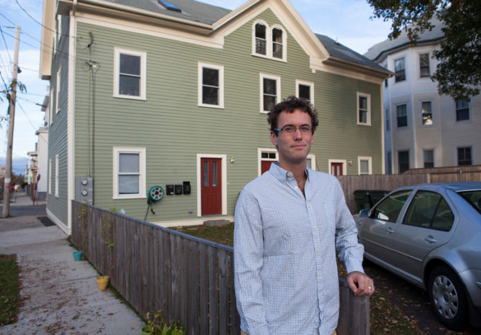 BUYING IN: Foreclosures have created opportunity for people looking to purchase triple-decker homes in Providence. Above, David Stuebe stands outside the triple-decker home he recently purchased on Ellery Street in Providence. / PBN PHOTO/DAVID LEVESQUE
