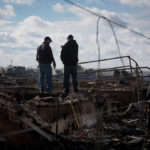 Industrial production in U.S. decreases 0.4% on Sandy effect RESIDENTS SURVEY the damage to their home in the Breezy Point neighborhood of the Queens borough of New York City on Wednesday, Oct. 31, 2012. / BLOOMBERG FILE PHOTO/SCOTT EELS