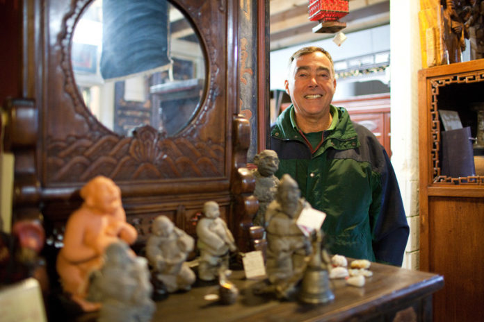 FINE CHINA: Mike Byrnes, who co-owns Olde China Trader in Bristol, was immersed in Eastern culture through military and embassy stints beginning in the 1980s. Most of the store’s inventory focuses on furniture and pottery, some dating back to the Ming dynasty. / PBN PHOTO/RUPERT WHITELEY