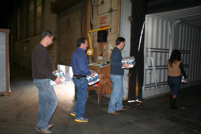 EMPLOYEES OF American Dryer Corp. recently donated supplies, including bottled water, to aid victims of Hurricane Sandy.