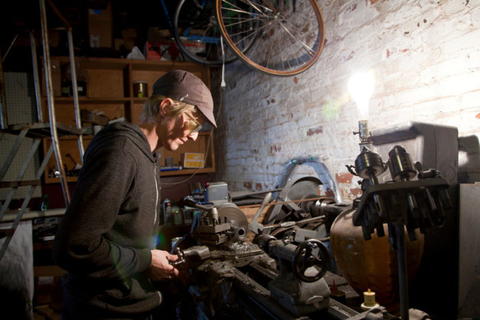 FRAMING THE CONVERSATION: Rhode Island has been home to a resurgence in the custom-bicycle-building industry. Above, Brian Chapman, a builder with Circle A Cycles who has also started his own line of custom frames called Chapman Cycles.  / PBN PHOTO/NATALJA KENT