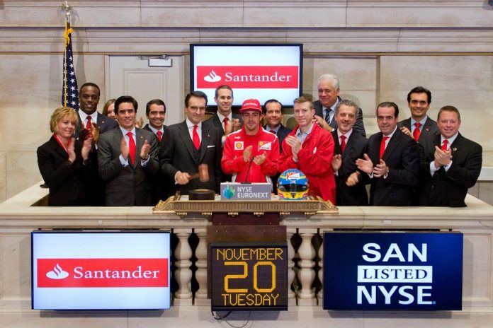 MARKING SOVEREIGN BANK-BANCO SANTANDER'S commitment to help victims of the Hurricane Sandy, Sovereign president and CEO Jorge Moran (with gavel) rang the bell to close the New York Stock Exchange on Nov. 20. The bank already has donated $250,000 to the American Red Cross and has committed up to $500,000 more in matching funds for relief efforts. Joining Moran were Fernando Alonso, center, two-time Formula One automobile driver champion and Josh Lockwood, in red jacket to Alonso's right, CEO of the New York region's Red Cross chapter. / COURTESY SOVEREIGN BANK MARKING SOVEREIGN BANK-BANCO SANTANDER'S commitment to help victims of the Hurricane Sandy, Sovereign president and CEO Jorge Moran (with gavel) rang the bell to close the New York Stock Exchange on Nov. 20. The bank already has donated $250,000 to the American Red Cross and has committed up to $500,000 more in matching funds for relief efforts. Joining Moran were Fernando Alonso, center, two-time Formula One automobile driver champion and Josh Lockwood, in red jacket to Alonso's right, CEO of the New York region's Red Cross chapter. / COURTESY SOVEREIGN BANK