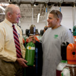 BROTHERLY LIVE: After more than 100 years as a family-owned business, Corp Brothers Inc. was recently purchased by T.A. Corporate Holdings. Above, Avery &ldquo;Whip&rdquo; Seaman Jr., left, president of Corp Brothers, speaks with sales representative Carlos Reyes. / PBN PHOTO/NATALJA KENT