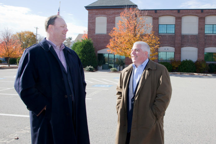 FIRM ROOTS: Peter Gladding, left, executive vice president of sales and marketing at Tunstall, speaks with Chief Information Officer Glenn Morin at the company’s new Pawtucket location. / PBN PHOTO/NATALJA KENT