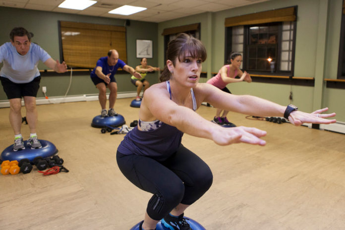 Denise Chakoian-Olney, fitness trainer and owner of Center of Real Energy in Providence, leads a Core Sweat Class. / PBN PHOTO/DAVID LEVESQUE