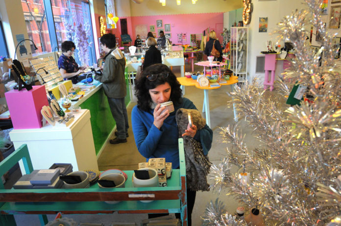 THINKING SMALL: Magda Caetano de Melo, forefront, shops at Craftland in downtown Providence on Black Friday. / PBN PHOTO/FRANK MULLIN