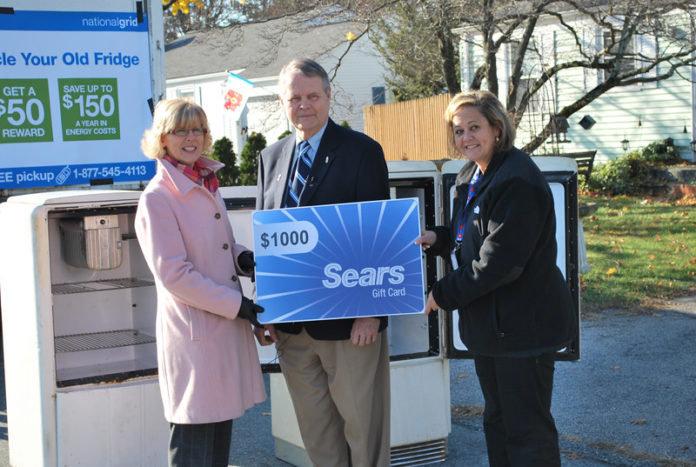 Cranston’s Robert Midwood, center, is presented with a $1,000 Sears Gift Card by National Grid representative Laurie Acone, left, and Sears representative Kelli Mahoney. Midwood was the owner of one of two 1939 General Electric refrigerators turned in during National Grid’s contest to identify the oldest refrigerators in the state. The competition was part of National Grid’s on-going program that pays customers $50 to turn in old, energy-inefficient refrigerators. / COURTESY NATIONAL GRID