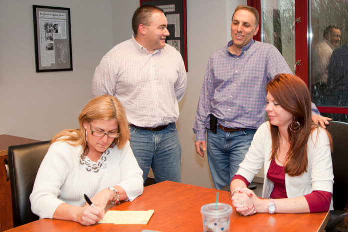 PARTY TIME? Workers at Priority Management Group discuss holiday-party benefits. From left: account manager Carla Rappa, Executive V.P. for Marketing and Technology Robert B. Skeffington, CPA Richard A. Santilli and Director Kristie Sellviveiros. / PBN PHOTO/NATALJA KENT