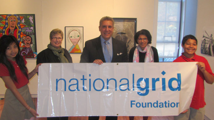 THE NATIONAL GRID FOUNDATION recently donated $9,600 to Read to Succeed. Pictured with students from Highlander Charter School are Barbara Papitto, program co-founder; Bob Keller, president of the National Grid Foundation; and Rose Mary Grant, Highlander’s head of school.
