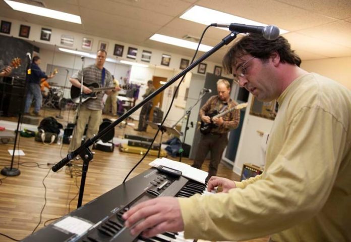Caswell Cooke, on keyboard, at a rehearsal for the Beach Band. The group was part of a Dec. 7 fundraising concert to benefit efforts to rebuild Misquamicut Beach and businesses that suffered damage due to Hurricane Sandy. Cooke is a Westerly town councilman and founder of the Misquamicut Business Association. / PBN PHOTO/DAVID LEVESQUE