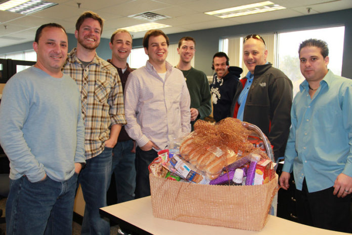 EMPLOYEES AT Embrace Home Loans recently gathered to assemble baskets for those in need during Thanksgiving. The 25 completed baskets contained food for a Thanksgiving meal and personal items.