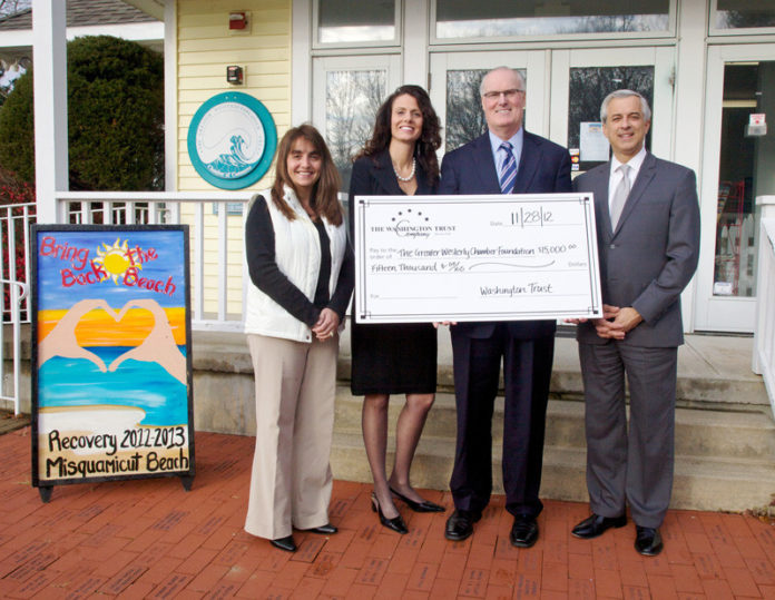 WASHINGTON TRUST CO. recently contributed $15,000 to Misquamicut Beach recovery efforts. Pictured from left to right are Deb Turrisi and Lisa Konicki of the Greater Westerly-Pawcatuck Chamber of Commerce with bank President and CEO Joseph J. MarcAurele and Dennis Algiere of Washington Trust.