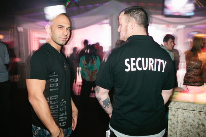 NIGHT LIFE: Colosseum nightclub co-owner Erik Tidd, left, with security staffer Josh Souza on a recent Saturday night at the club. / PBN PHOTO/RUPERT WHITELEY