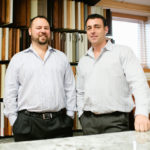COUNTER POINT: Joe Pakuris, left, and Eddy Keegan are co-owners of Kitchen Countertop Center of New England, a custom-renovation company. They say the firm’s business has grown 20 percent each year they’ve been in business. / PBN PHOTO/RUPERT WHITELEY