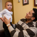 OFF COURSE: Jhon Pino holding his 18-month-old daughter, Serenity. Pino, 21, enrolled at Sawyer six months ago and was shocked by the abrupt closing. / PBN PHOTO/DAVID LEVESQUE