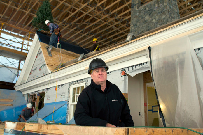 BUILT TO SCALE: Parker Construction Company Inc. President Glenn A. Parker, above in foreground, says that the recovering building sector has pushed firms toward more small projects than in the past. / PBN PHOTO/KATE WHITNEY LUCEY