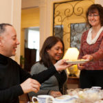 STAY A WHILE: Anne Tundermann, owner of Providence&rsquo;s Annie Brownell House, serves breakfast to two out-of-towners: Victor Rodriguez and Annecy Baez, both of New York City. Tundermann&rsquo;s bed-and-breakfast has been around for 14 years. / PBN PHOTO/DAVID LEVESQUE