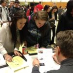 Credit for Life offers financial literacy training Wayne Swenson, vice president and consumer loan officer at BayCoast Bank, discusses credit cards and loan options with Greater New Bedford Vocational Tech students Kelci Raposo, left,and Marlene Cerritos.