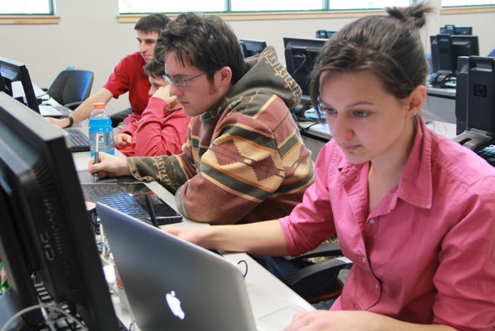 Game designers work on the art and programming code for their game during the 2013 Global Game Jam at New England Institute of Technology. The 48-hour, game-design event was held Jan. 25-27 at 317 jam sites in 60 countries and included tens of thousands of participants. NEIT had 54 contestants, including from left, Matthew Karn, NEIT graduate, Chase Hermanson, NEIT graduate, Rhode Island School of Design senior Chris Culbertson and Allisandra Briggs, RISD senior. / COURTESY NEIT