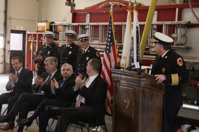 JOB WELL DONE. Fire Chief William Sisson (at podium) is joined by (front, from left) Congressman David Cicilline, U.S. Sens. Sheldon Whitehouse and Jack Reed and Pawtucket Mayor Donald R. Grebien in commending the grant-application work of Fire Lieutenants Gil Woodside and Ed Shotteck (rear, right to left), also applauded by Lt. Will Maher. / COURTESY CITY OF PAWTUCKET JOB WELL DONE. Fire Chief William Sisson (at podium) is joined by (front, from left) Congressman David Cicilline, U.S. Sens. Sheldon Whitehouse and Jack Reed and Pawtucket Mayor Donald R. Grebien in commending the grant-application work of Fire Lieutenants Gil Woodside and Ed Shotteck (rear, right to left), also applauded by Lt. Will Maher. / COURTESY CITY OF PAWTUCKET