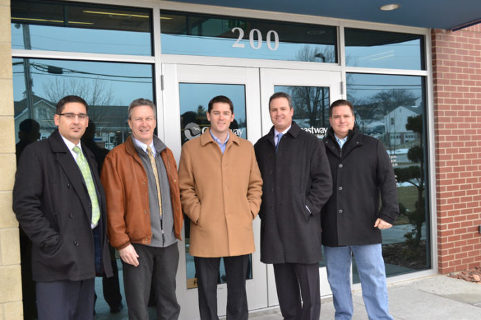 Coastway Community Bank opened a prototype retail branch on Comstock Parkway in Cranston on Jan. 28. The branch is intended to be the first of multiple locations for the design, which uses traditional materials of brick, stone and glass. Pictured from left, from Vision 3 Architects: Joseph Caldeira, project manager; Keith Davignon, principal; Andrew Hausmann, architect; and from E. Turgeon Construction Corp, Christopher Ducharme, principal, and Peter Abbenante, project manager. / COURTESY VISION 3 ARCHITECTS