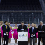 MEMBERS OF THE WARWICK Figure Skaters provide a backdrop for the announcement that Providence and Warwick will host the 2015 U.S. Synchronized Skating National Championships.  From left: RI Convention Center Authority Chairman Jim Bennett; Providence Mayor Angel Taveras; RI Sports Commission Executive Director John Gibbons; Warwick Figure Skaters Spokesman Don McKenzie and Warwick Mayor Scott Avedisian. / COURTESY THE R.I. SPORTS COMMISSION