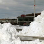 SHOVELING OUT: Closing early Friday, Feb. 8, in advance of the blizzard, Warwick Mall didn't open again until the following Sunday morning. One of the biggest challenges was clearing the shopping center's 5,000-space parking lot. / PBN PHOTO/BRIAN MCDONALD