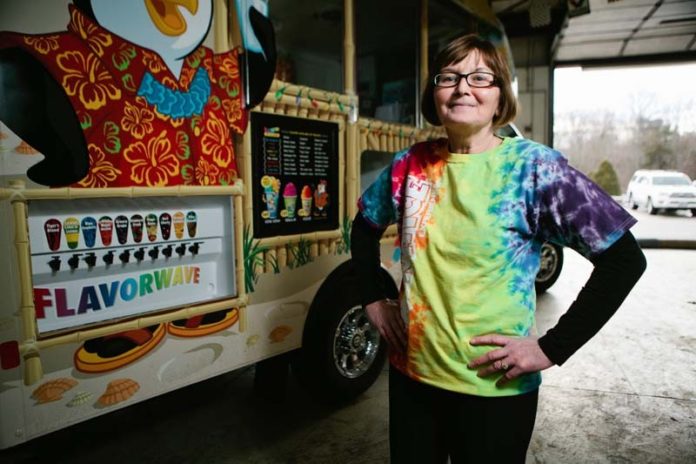 FROZEN ASSETS: Joyce Bouchard next to her Kona Ice truck. She and her husband launched a business selling shaved ice last summer. / PBN PHOTO/RUPERT WHITELEY