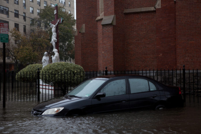 A CAR SITS SUBMERGED in water on a flooded street in Hoboken, N.J., after Hurricane Sandy.  / BLOOMBERG FILE PHOTO/EMILE WAMSTEKER