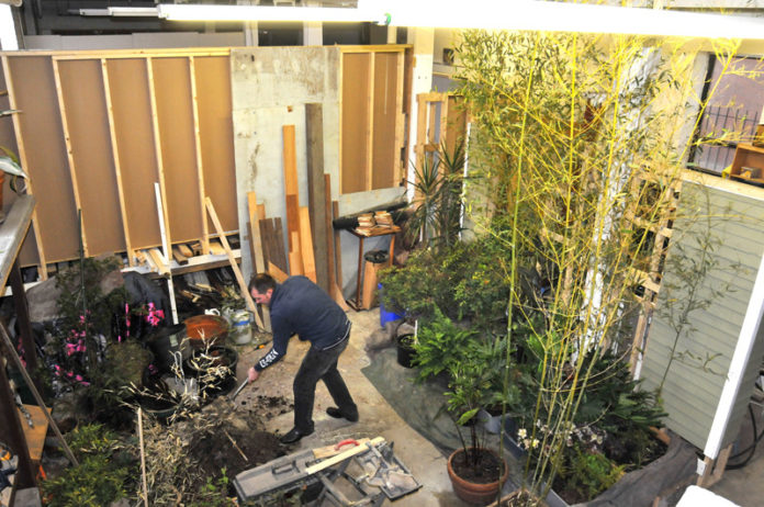 SURVEYING THE LANDSCAPE: Joe Novak, founder of Novac Garden Design & Construction, has found a home for his business in the Butcher Block Mill and has benefited from the location’s ability to foster collaboration. / PBN PHOTO/FRANK MULLIN
