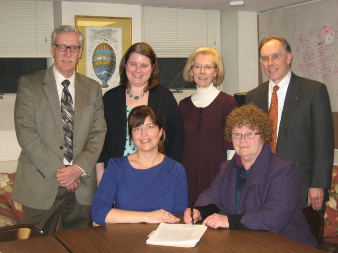 THE WOMEN'S CENTER OF Rhode Island and Crossroads Rhode Island have signed an affiliation agreement to help address the connection between domestic violence and homelessness. (Standing, from left: Chris Woulfe, Kris Lyons, Vera Gierke, Scot Jones.  Sitting, from left: Virginia Branch, Anne Nolan) / COURTESY CROSSROADS RHODE ISLAND/WOMEN'S CENTER OF RHODE ISLAND