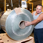 GLOBAL OUTLOOK: Hope Global CEO Cheryl Merchant says the workforce is the cornerstone of R.I.&rsquo;s manufacturing industry. Pictured above is Hope Global machine operator Julio Martinez. / PBN PHOTO/NATALJA KENT