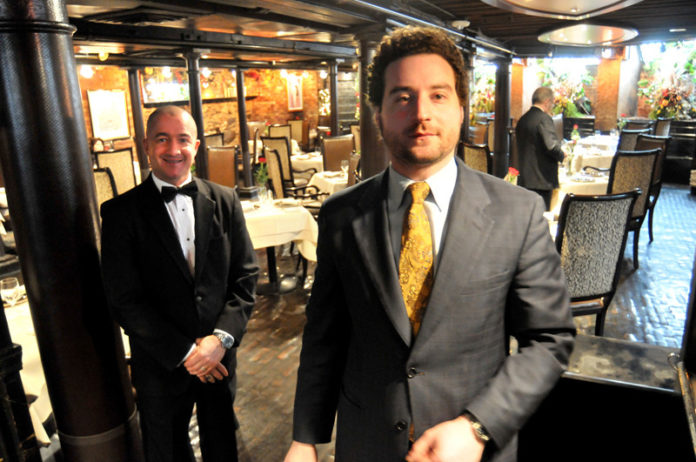BUSINESS TIME: Salvatore Iemma, right, manager, with Donald Poissant, at Capriccio. The restaurant has benefited from lunch meetings of Providence’s power brokers. / PBN PHOTO/FRANK MULLIN