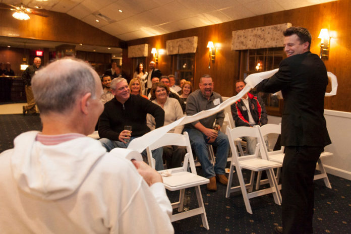 MORE THAN MEETS THE EYE: Magician Mat Francoed performs during a Feb. 27 Central Rhode Island Chamber of Commerce event. Chambers are using such social events to lure new members. / PBN PHOTO/DAVID LEVESQUE