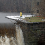 THE MARCH 2010 FLOODS put extra stress on many Rhode Island dams. The American Society of Civil Engineers report scored the state for not having any emergency action plans for its dams. Here, workers from Leslandes Construction work to ensure that the dam at Natick Mill does erode and fail due to rising water. / PBN FILE PHOTO/BRIAN MCDONALD