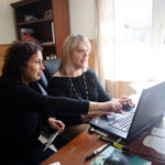 Tech cos.’ bridge gap between work, community needs HELPING HANDS: Cynthia Toti, left, inside sales manager for Bridge Technical Talent, helps The Greene School Assistant Principal Melissa Hall learn how to use salesforce.com. / PBN PHOTO/STEPHANIE ALVAREZ EWENS