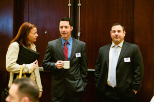 Joan Greenwell, Starkweather & Shepley, talks with David Glade and Jeff Minuto of USI Insurance / Rupert Whiteley