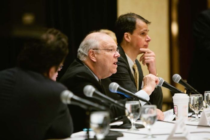 IDEAS EXCHANGE: Tufts Health Plan President and CEO James Roosevelt Jr., speaking, wearing glasses, says that the insurer is committed to the R.I. Health Benefits Exchange. / PBN PHOTO/RUPERT WHITELEY