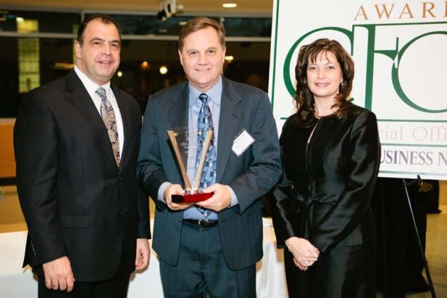Jeffrey Burchill, CFO of FM Global, accepts his Career Achievement Award from Chris Santilli and Kristin Fraser / Rupert Whiteley