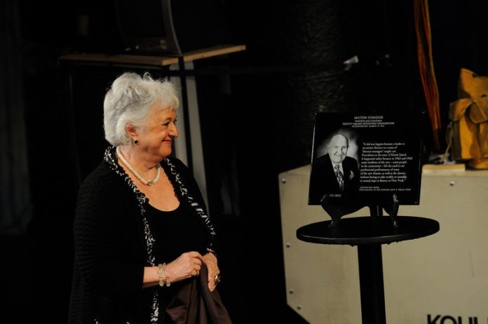 DURING AN EVENT honoring the theater’s supporters, Selma Stanzler smiles at a plaque honoring her late husband, Milton Stanzler, a founder of Trinity Repertory Co.