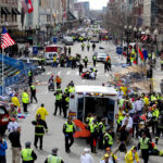 FIRST RESPONDERS tend to the wounded where two explosions occurred along the final stretch of the Boston Marathon on Boylston Street in Boston, Massachusetts, U.S., on Monday, Two powerful explosions rocked the finish line area of the Boston Marathon near Copley Square and police said many people were injured. / BLOOMBERG PHOTO/KELVIN MA