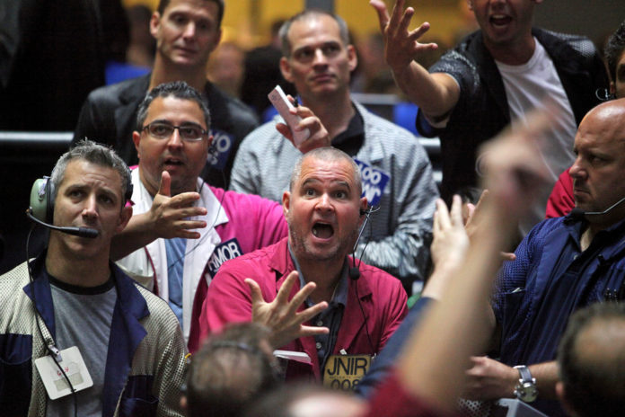 STOCK FUTURES were little changed in the U.S. Wednesday morning after the Dow Jones Industrial Average climbed above 15,000 for the first time ever Tuesday. / BLOOMBERG FILE PHOTO/TIM BOYLE STOCK FUTURES were little changed in the U.S. Wednesday morning after the Dow Jones Industrial Average climbed above 15,000 for the first time ever Tuesday. / BLOOMBERG FILE PHOTO/TIM BOYLE