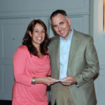 Embrace donates $30K to 12 LOAN OFFICER Melissa Bjorklund receives a Teammate of the Year award from Embrace Home Loans President Kurt Noyce.