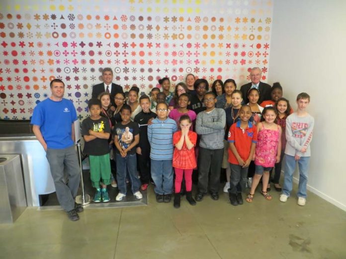 PARTRIDGE SNOW & HAHN LLC recently gave 25 tickets to the Boys & Girls Club of Pawtucket for a docent-led tour of the Museum of Art, Rhode Island School of Design. Pictured are club members along with firm members David M. Gilden, rear, left, and John J. Partridge, rear, right.