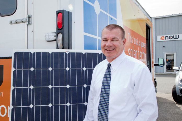 SEE THE LIGHT: Jeff Flath, president and CEO of eNow, shows off a demo truck for the company’s lightweight, plastic, solar panel. / PBN PHOTO/NATALJA KENT