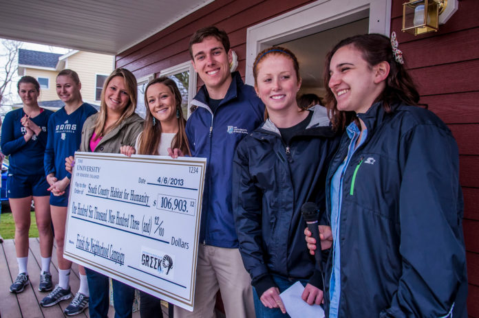 FROM LEFT TO RIGHT, URI students Frankie Darnold, Jill Anderson, Jaime Giacomelli, Corrine Reed, Rob Tobey, Kristin Pollard and Julia Garrick pose with the check being donated to South County Habitat for Humanity. / COURTESY URI/MICHAEL SALERNO PHOTOGRAPHY
